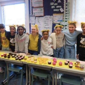 Students with cakes on the table