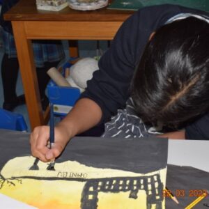 Student drawing onto painting