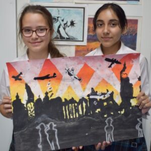 Students holding painting