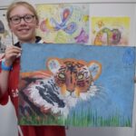 Student with tiger painting