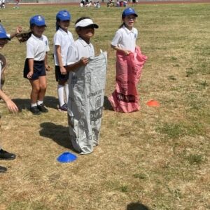 students in sacks for jumping